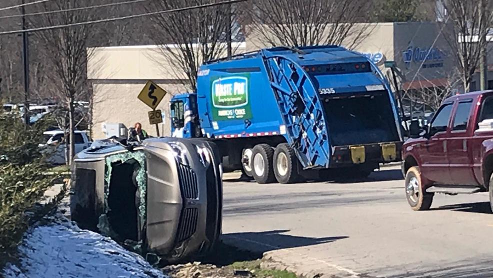 Vehicle ends up on its side after crash with garbage truck; No injuries
