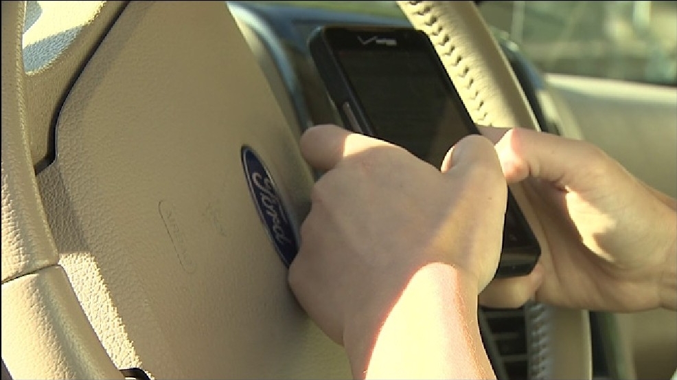 distracted driving holding phone at wheel.jpg distracted driving holding phone at wheel.jpg