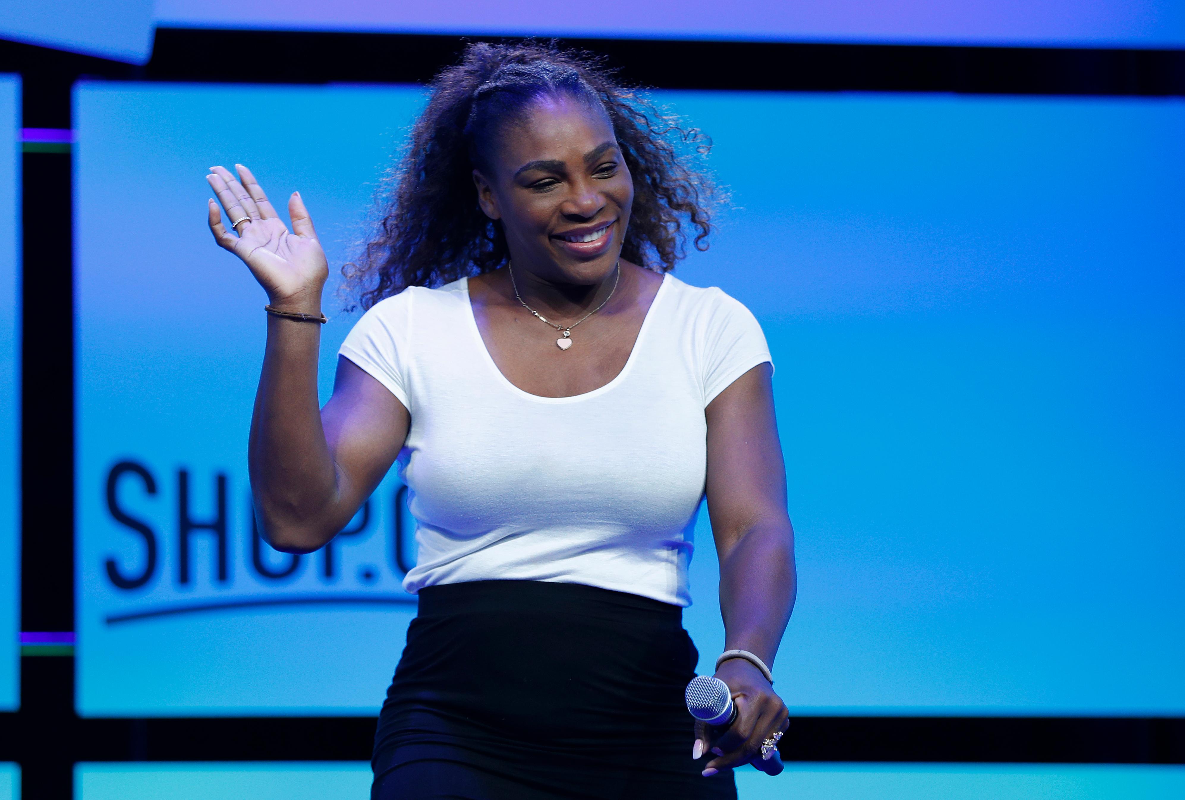 tennis star serena williams walks on stage before speaking at