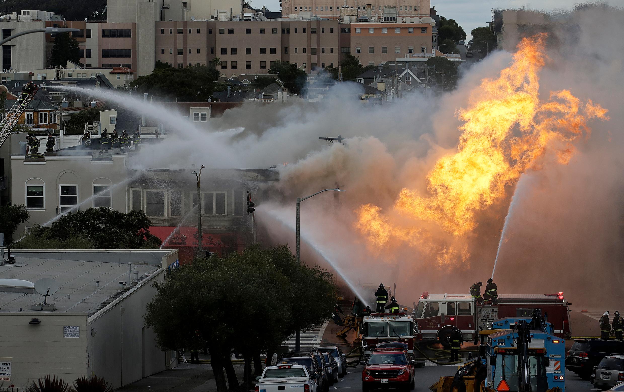 san francisco firefighters battle a fire on geary boulevard in